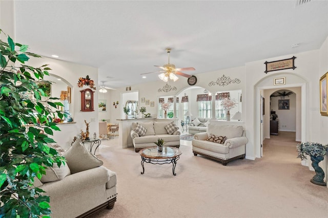 carpeted living room with ceiling fan