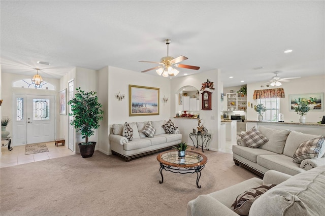 living room featuring ceiling fan and light colored carpet