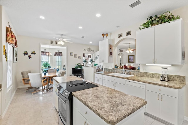 kitchen featuring white dishwasher, white cabinetry, stainless steel range with electric stovetop, and sink