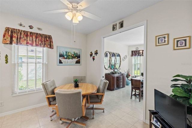 tiled dining area featuring ceiling fan and plenty of natural light