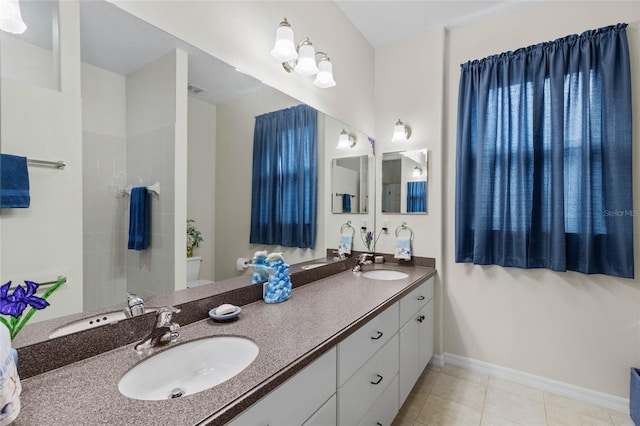 bathroom with tile patterned floors, vanity, and toilet