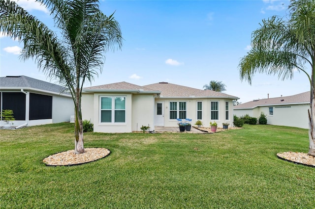 rear view of property with a patio area and a lawn