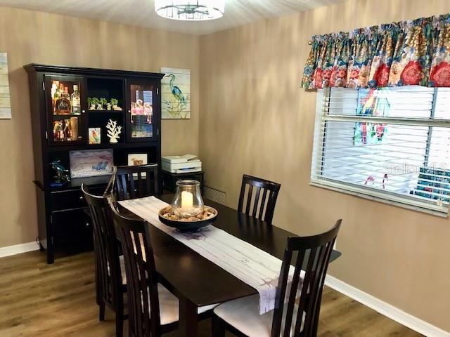 dining room with dark hardwood / wood-style flooring