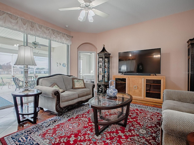 tiled living room featuring ceiling fan