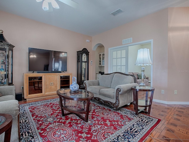 living room with parquet flooring and ceiling fan