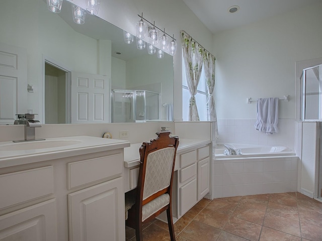 bathroom featuring vanity and independent shower and bath