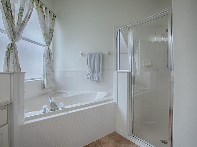 bathroom featuring vanity, tile patterned floors, and plus walk in shower