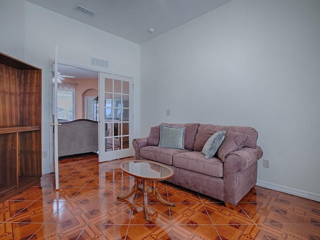 living room with vaulted ceiling, ceiling fan, and french doors