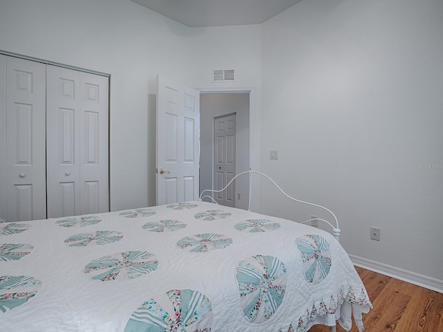 bedroom featuring hardwood / wood-style floors and a closet