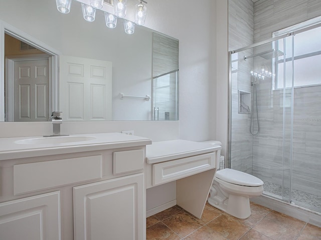 bathroom with vanity, toilet, and a shower with shower door