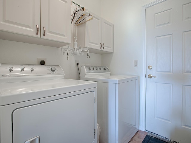 laundry room with cabinets and washing machine and dryer