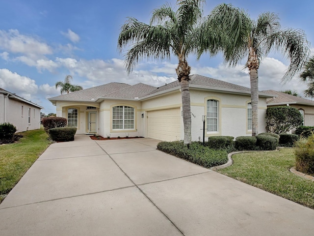 view of front of house with a garage and a front yard