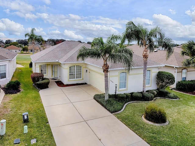 view of front of property with a garage and a front lawn