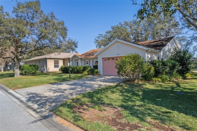 ranch-style house with a garage and a front lawn