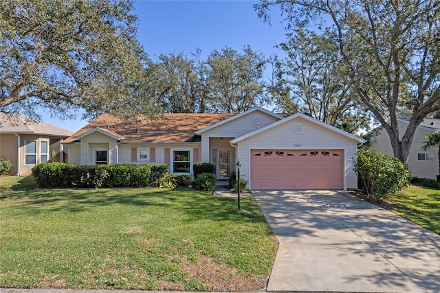 ranch-style house with a front yard and a garage