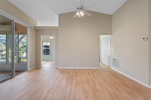 unfurnished room featuring lofted ceiling, ceiling fan, and light hardwood / wood-style flooring