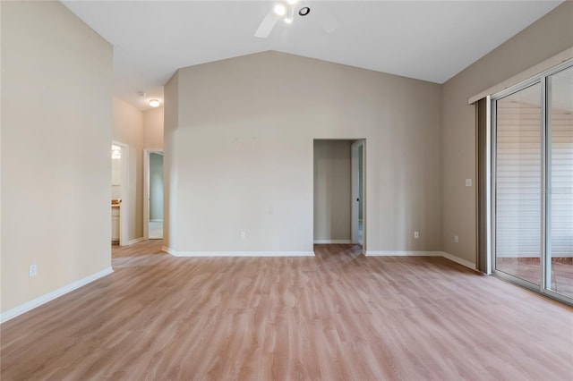 spare room with ceiling fan, light wood-type flooring, and vaulted ceiling