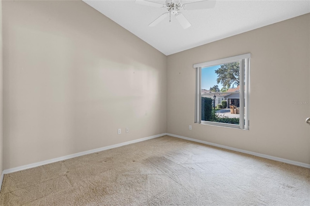 unfurnished room with ceiling fan, vaulted ceiling, and carpet