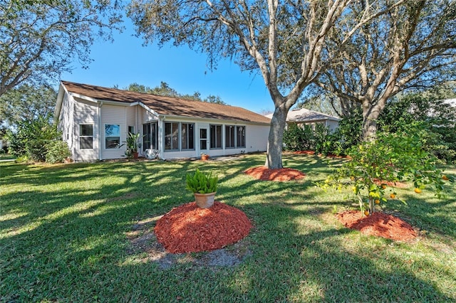 rear view of property with a lawn