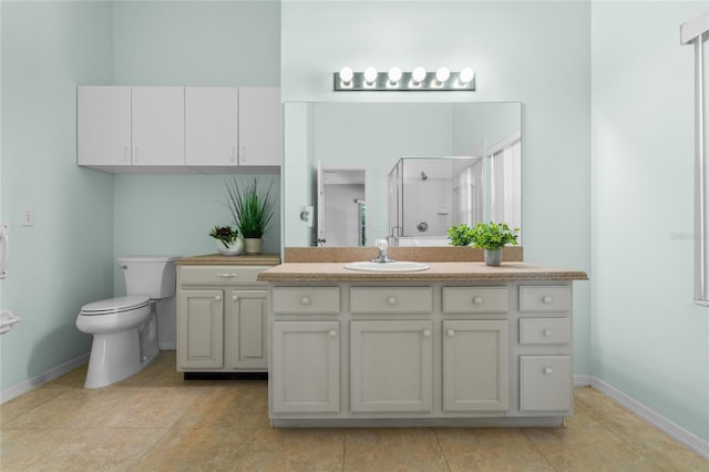 bathroom with an enclosed shower, vanity, tile patterned floors, and toilet