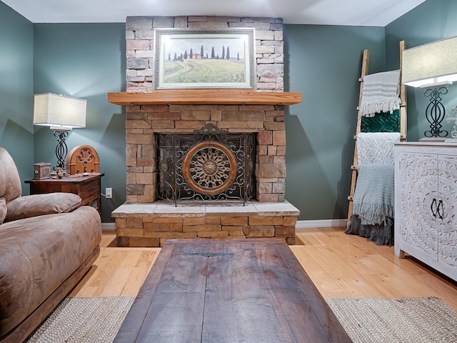 living area with a fireplace and hardwood / wood-style flooring