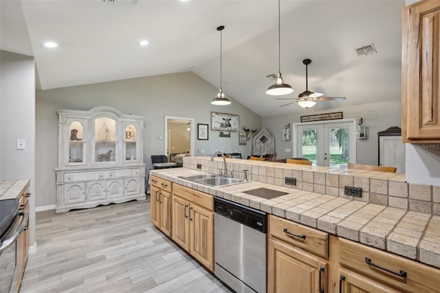 kitchen featuring vaulted ceiling, stainless steel appliances, ceiling fan, sink, and light hardwood / wood-style flooring