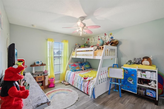 bedroom featuring ceiling fan and hardwood / wood-style flooring