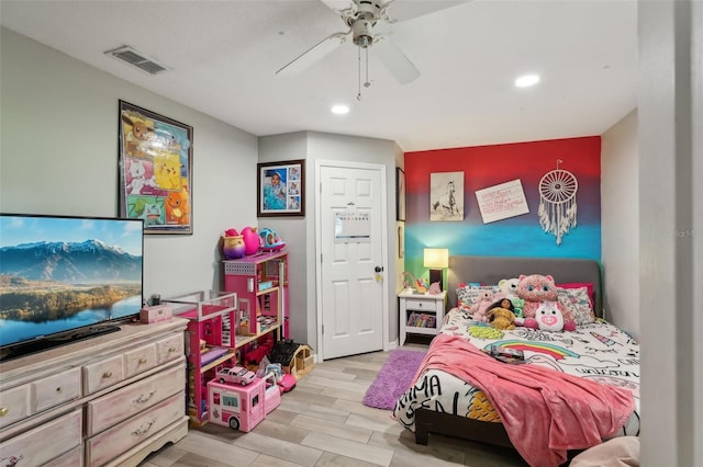 bedroom with ceiling fan and light hardwood / wood-style flooring