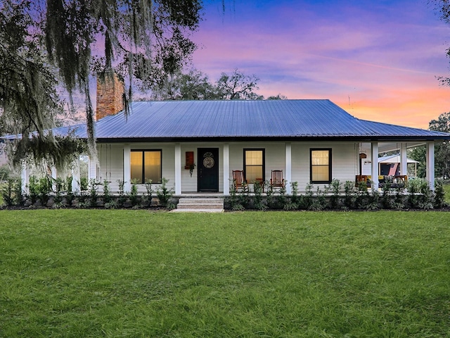 view of front facade featuring a yard and covered porch