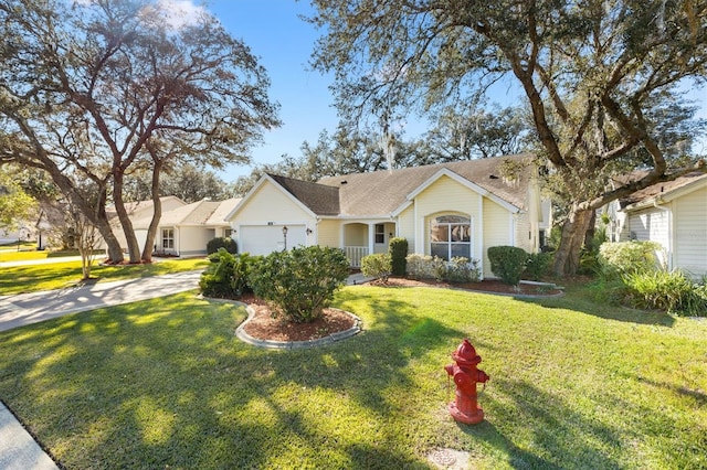 view of front of property with a front yard and a garage