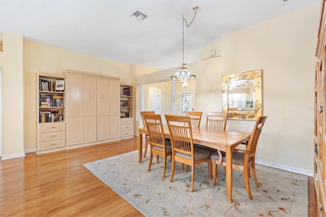 dining room featuring a chandelier and light wood-type flooring