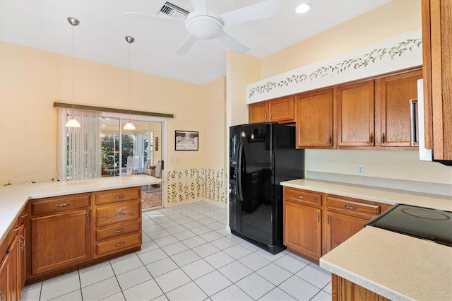 kitchen featuring decorative light fixtures, black refrigerator with ice dispenser, ceiling fan, light tile patterned floors, and kitchen peninsula