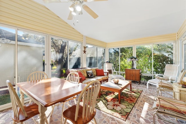 sunroom / solarium with ceiling fan, vaulted ceiling, and a wealth of natural light