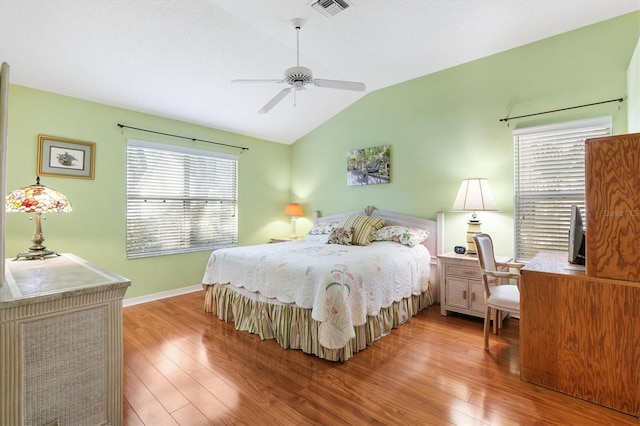 bedroom with lofted ceiling, multiple windows, ceiling fan, and light hardwood / wood-style floors