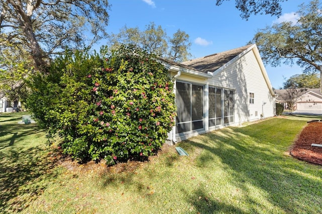 view of side of home with a yard