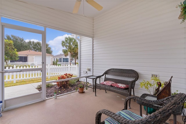 sunroom / solarium featuring ceiling fan