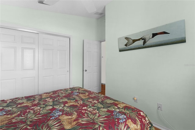 bedroom with ceiling fan and a closet