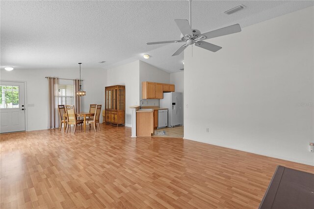 424 Rose Croft Ter, The Villages, FL 32162 - living area with light wood-style floors, ceiling fan, a textured ceiling, and vaulted ceiling