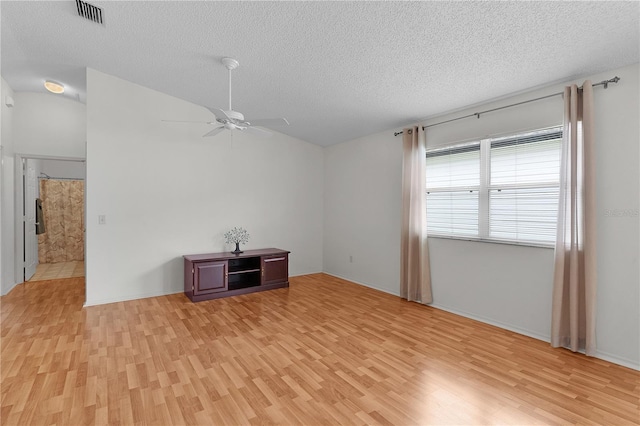 424 Rose Croft Ter, The Villages, FL 32162 - unfurnished living room featuring light wood finished floors, ceiling fan, and a textured ceiling