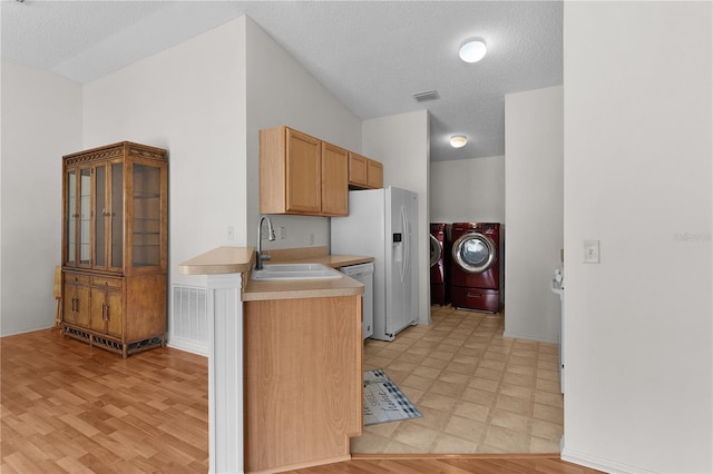 424 Rose Croft Ter, The Villages, FL 32162 - kitchen featuring washer and clothes dryer, a sink, light countertops, a textured ceiling, and light floors