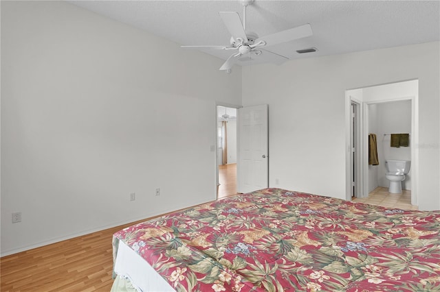 424 Rose Croft Ter, The Villages, FL 32162 - bedroom with a textured ceiling, light wood finished floors, ensuite bathroom, ceiling fan, and vaulted ceiling