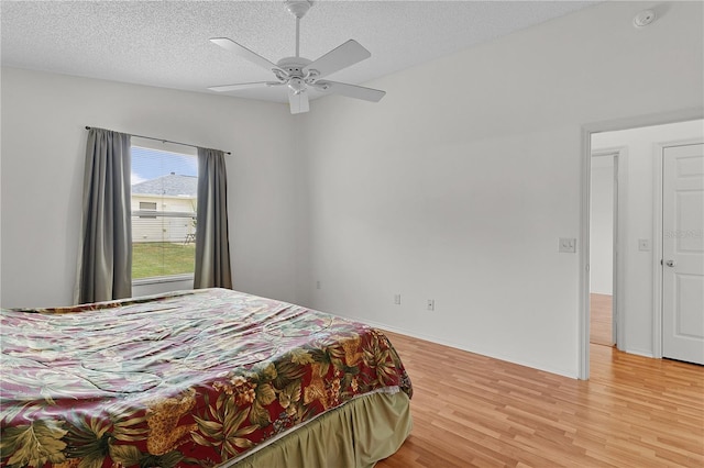 424 Rose Croft Ter, The Villages, FL 32162 - bedroom featuring light wood finished floors, a textured ceiling, and a ceiling fan