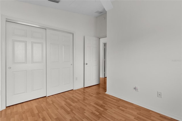 424 Rose Croft Ter, The Villages, FL 32162 - unfurnished bedroom with light wood finished floors, a closet, and baseboards