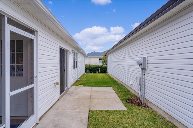 424 Rose Croft Ter, The Villages, FL 32162 - view of side of property with a patio area and a lawn