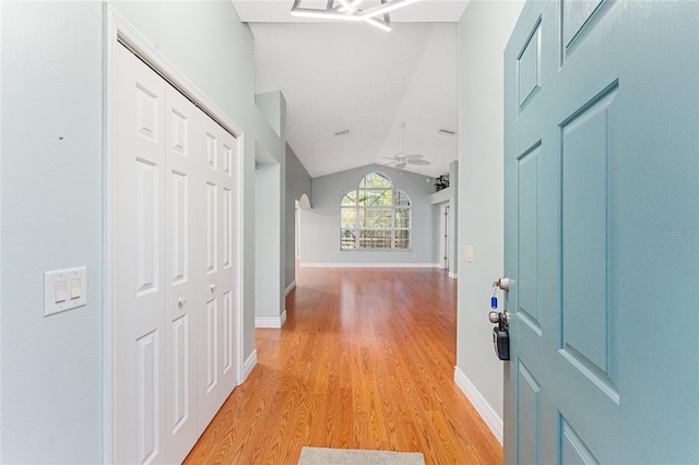 interior space featuring ceiling fan, light hardwood / wood-style floors, and vaulted ceiling