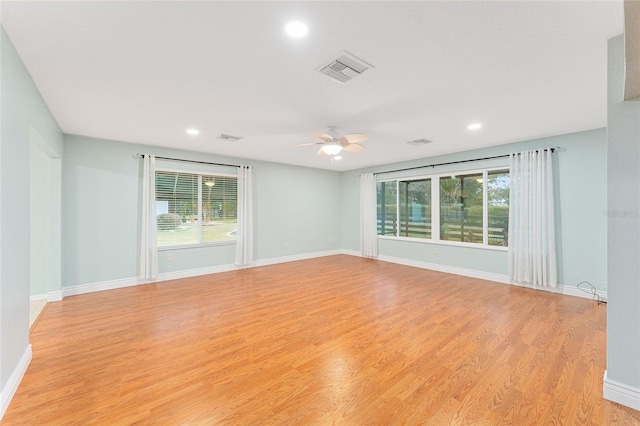 spare room with light wood-type flooring and ceiling fan