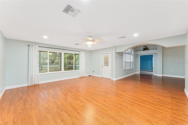 unfurnished living room with ceiling fan and light hardwood / wood-style flooring