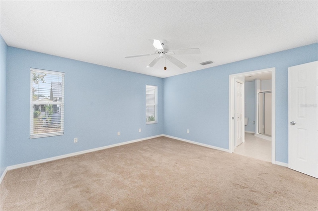 carpeted spare room with ceiling fan