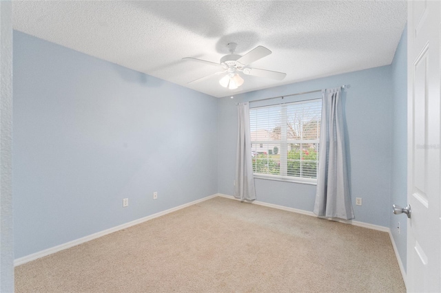 carpeted empty room with a textured ceiling and ceiling fan