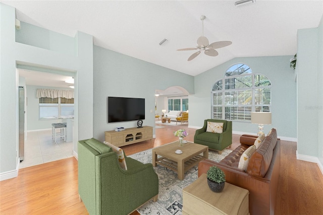 living room featuring ceiling fan, light hardwood / wood-style flooring, and lofted ceiling